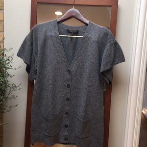 Soft grey cardigan sweater with tulip sleeves.